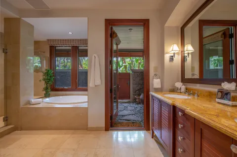 a bathroom with a shower sink and mirror