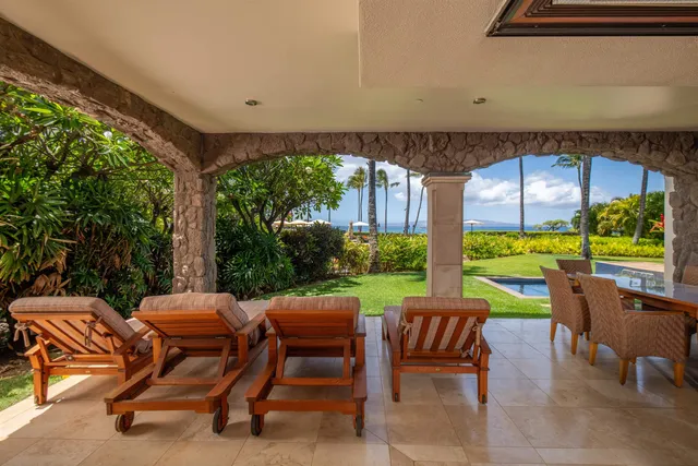 a view of a dining room with furniture a kitchen and chandelier