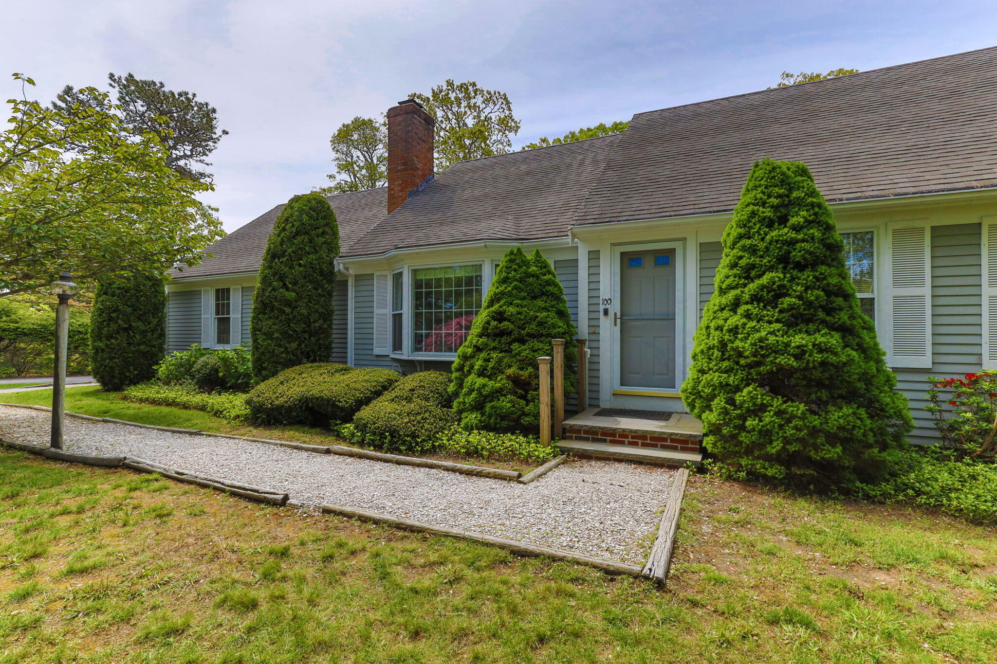 100 Potonumecot Road Chatham, MA 02633 - Photo 3 of 40 a front view of a house with garden