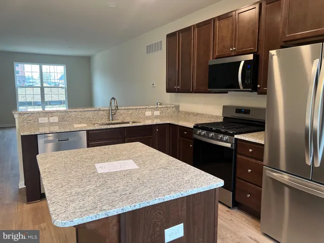 a kitchen with a sink stove and refrigerator