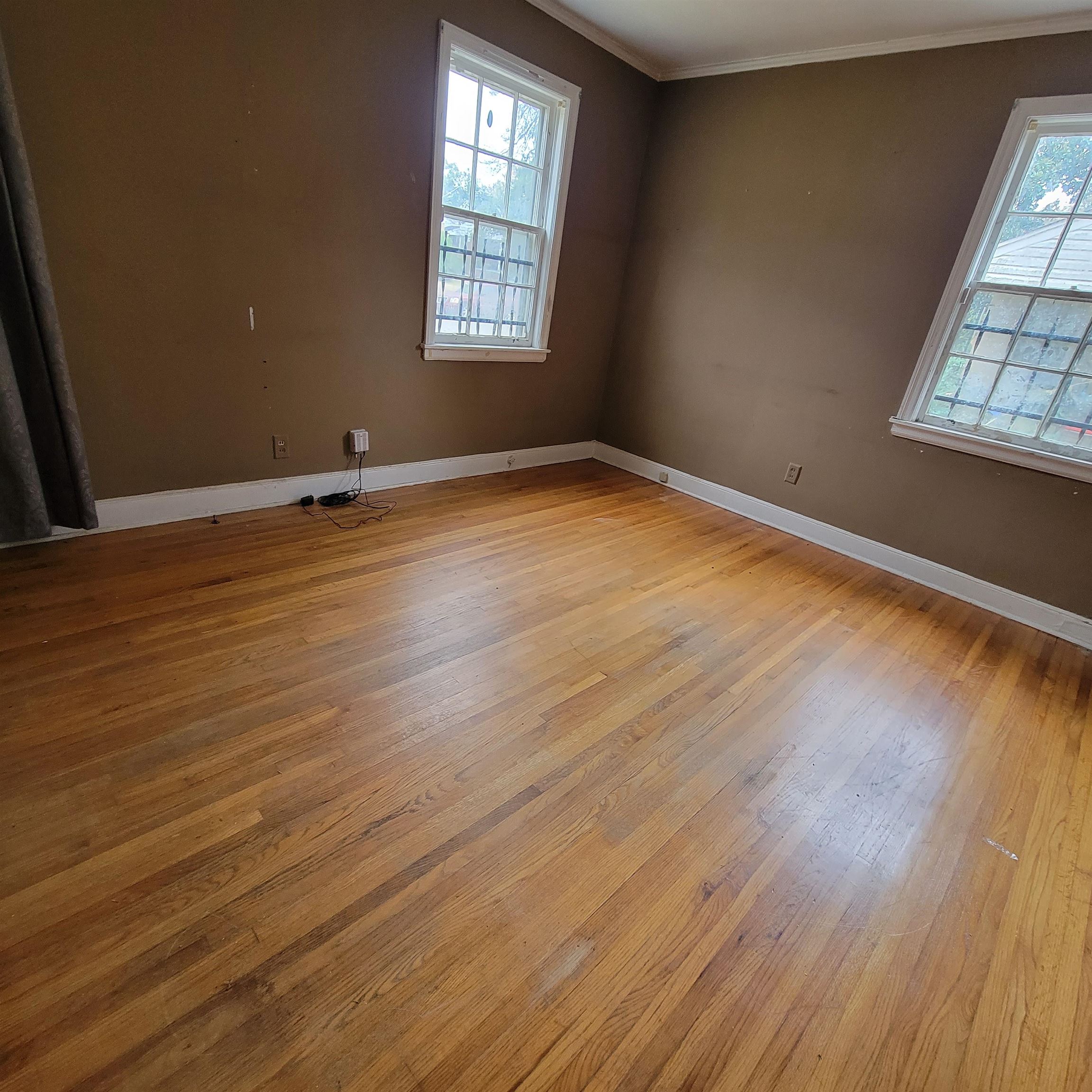 157 Roberta Drive Memphis, TN 38112 - Photo 9 of 25 an empty room with wooden floor and windows