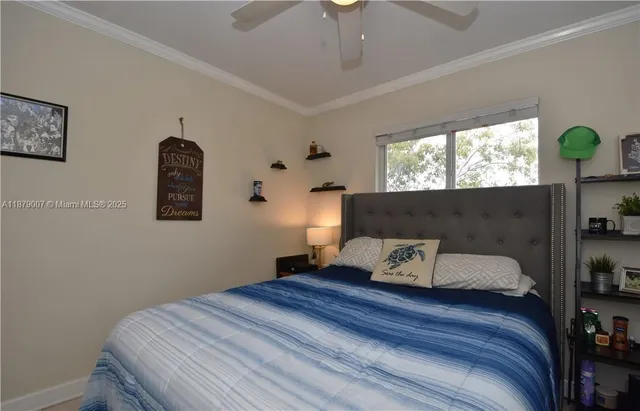 a bedroom with bed and window