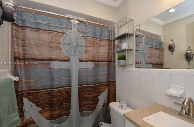 a bathroom with a shower toilet and sink