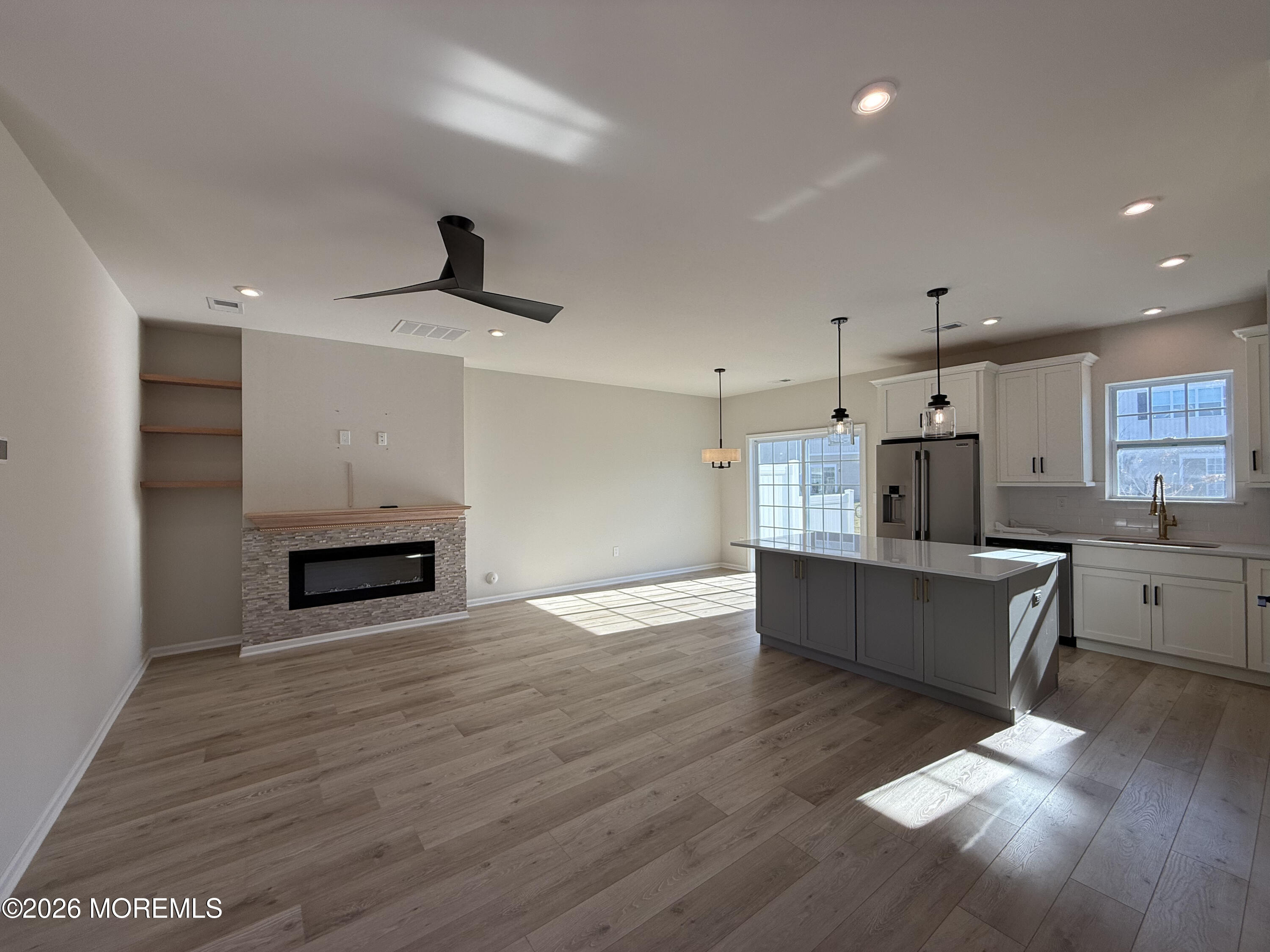 20 Laird Way Neptune, NJ 07753 - Photo 11 of 32 a large kitchen with stainless steel appliances refrigerator stove microwave and cabinets