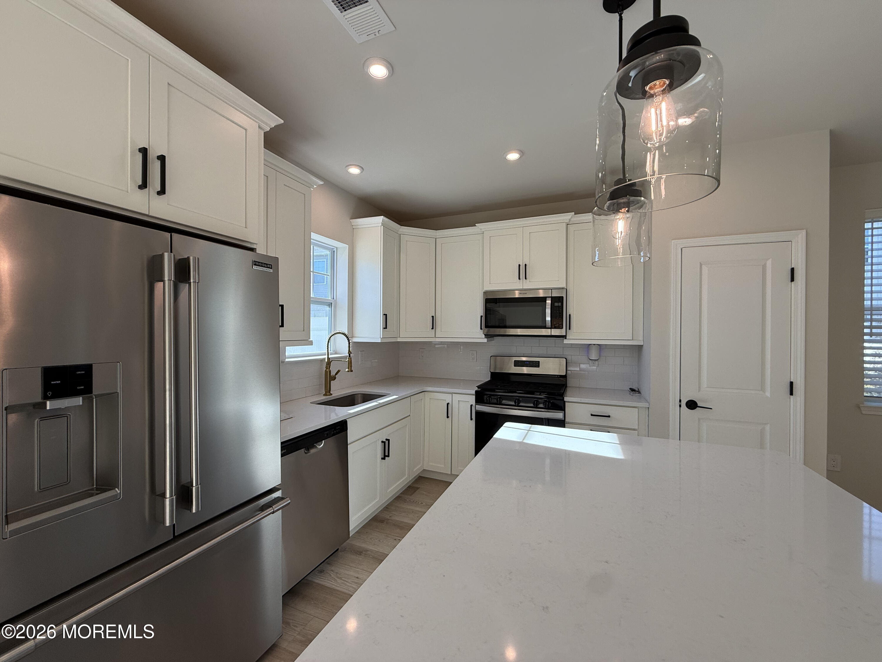 20 Laird Way Neptune, NJ 07753 - Photo 14 of 32 a kitchen with granite countertop a refrigerator stove and microwave