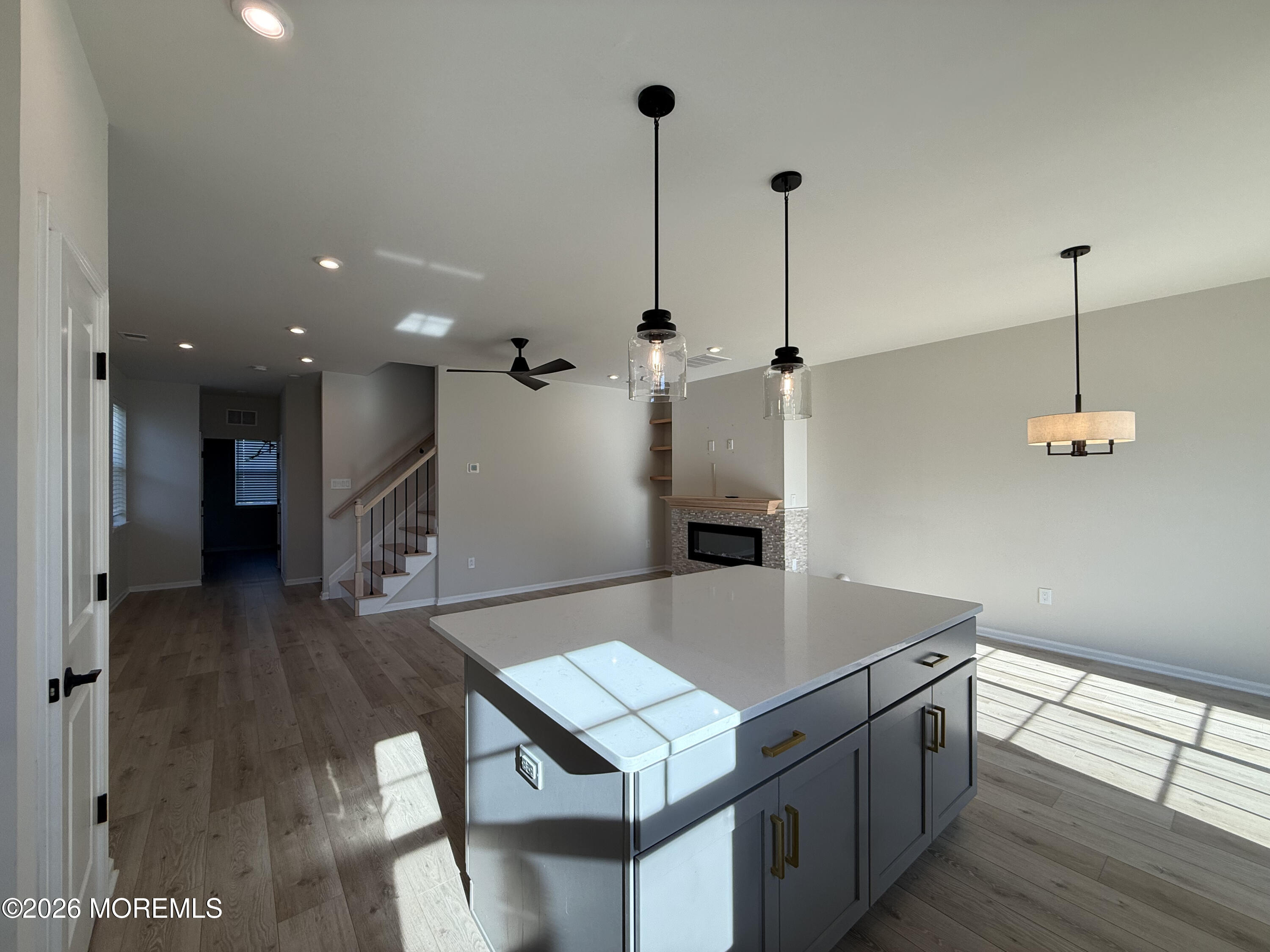 20 Laird Way Neptune, NJ 07753 - Photo 15 of 32 a kitchen with kitchen island a stove and a wooden floor