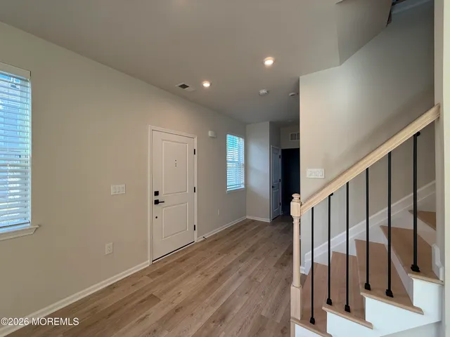 a view of an empty room and wooden floor