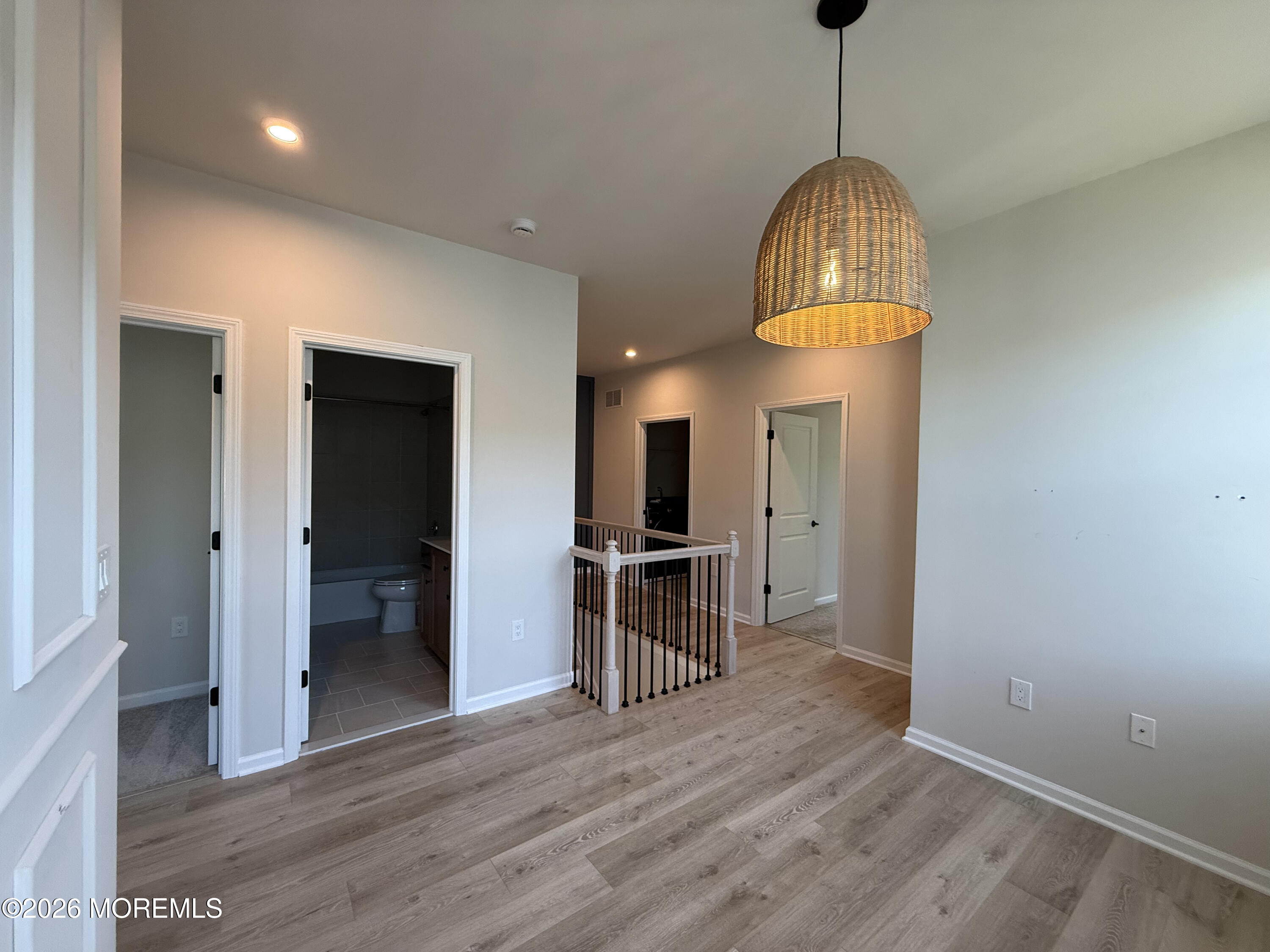 20 Laird Way Neptune, NJ 07753 - Photo 29 of 32 a view of empty room with wooden floor and kitchen view