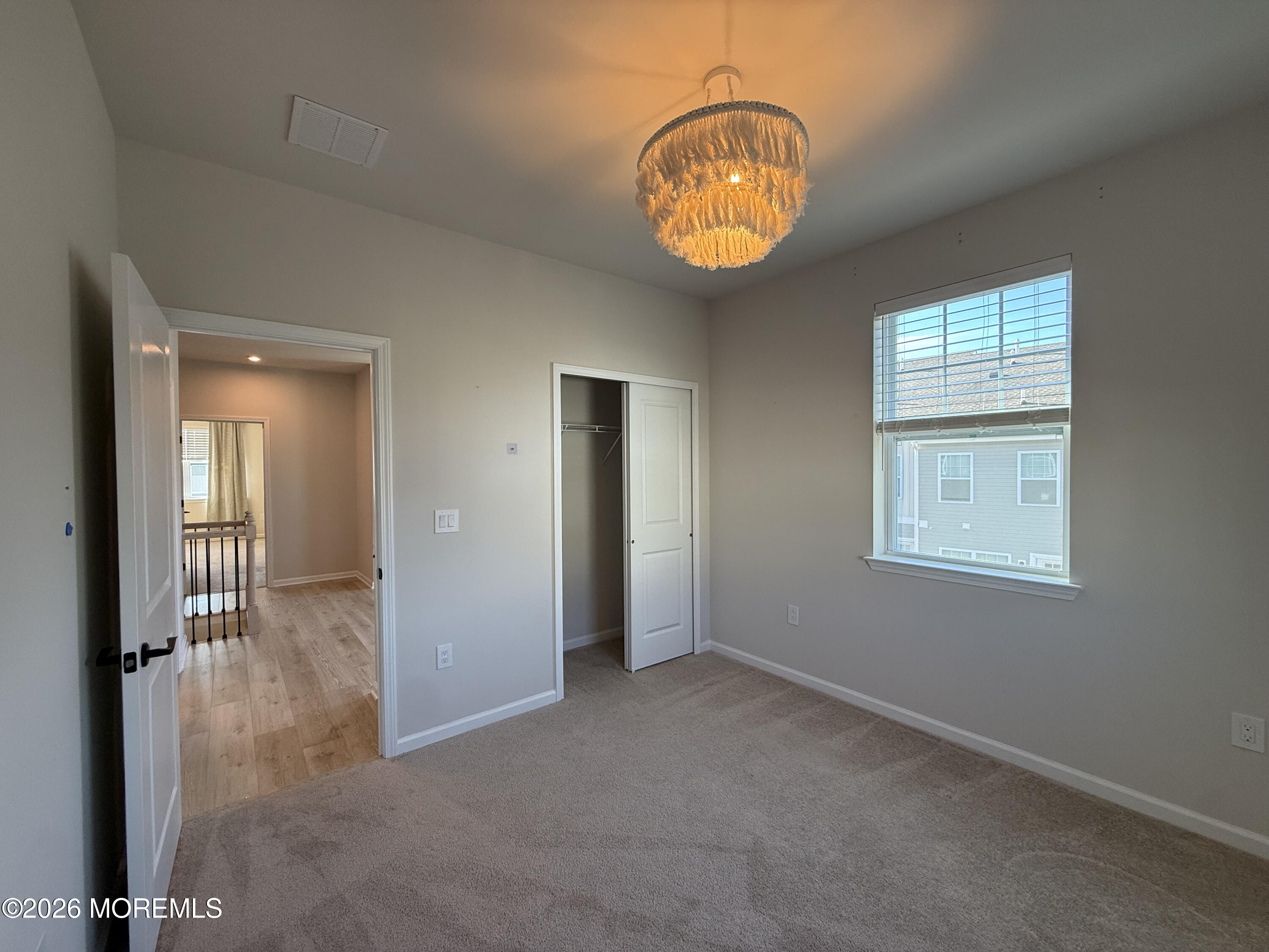 20 Laird Way Neptune, NJ 07753 - Photo 31 of 32 an empty room that has a chandelier fan and a window