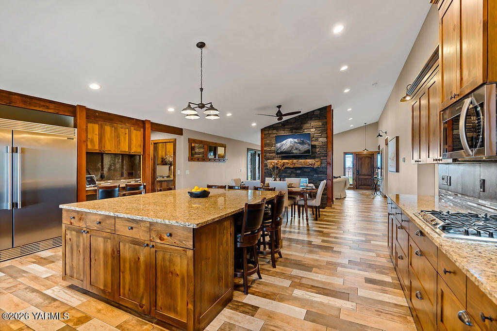 3344 Marks Road Yakima, WA 98903 - Photo 14 of 56 a large kitchen with stainless steel appliances granite countertop a stove oven a dining table and chairs with wooden floor