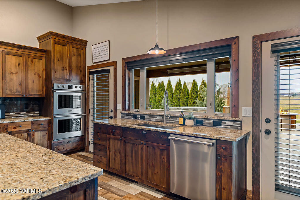 3344 Marks Road Yakima, WA 98903 - Photo 17 of 56 a kitchen with stainless steel appliances granite countertop a stove a sink and a microwave