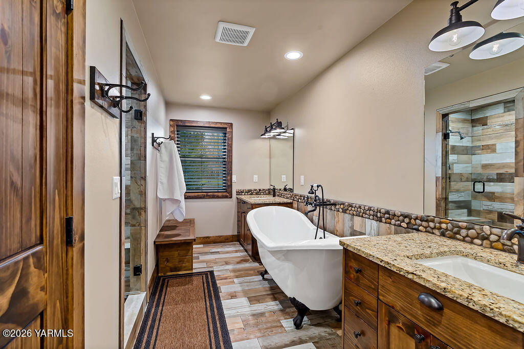 3344 Marks Road Yakima, WA 98903 - Photo 27 of 56 a bathroom with a granite countertop sink a toilet a mirror and shower