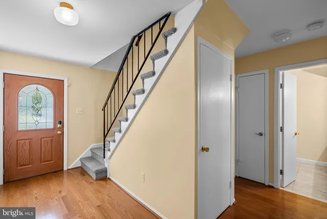a view of entryway with wooden floor and stairs