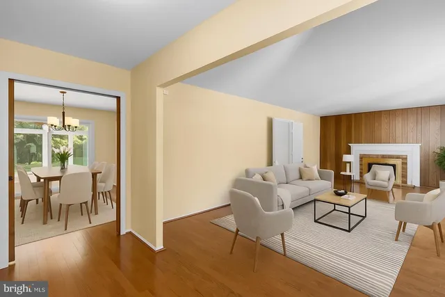 a living room with furniture a fireplace and a table