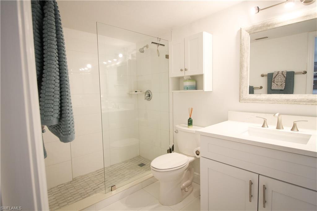 97 Georgetown Boulevard, Unit 97 Naples, FL 34112 - Photo 17 of 26 a bathroom with a sink a toilet and shower