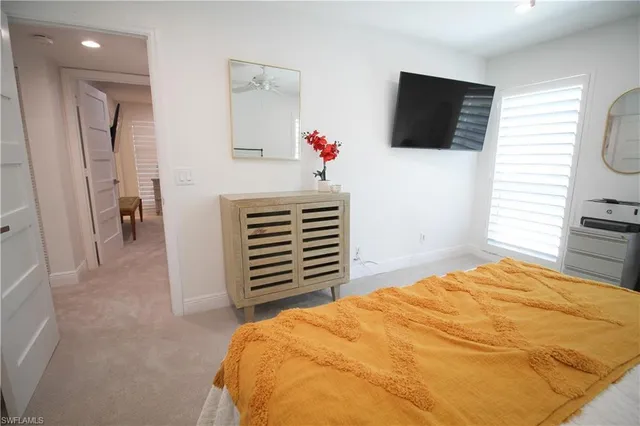 a bed room with a bed and a chair