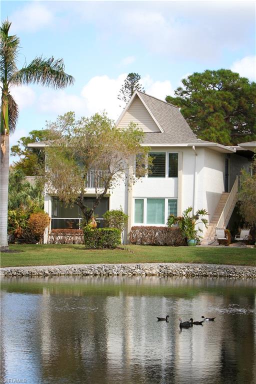 97 Georgetown Boulevard, Unit 97 Naples, FL 34112 - Photo 3 of 26 a front view of a house with a lake view