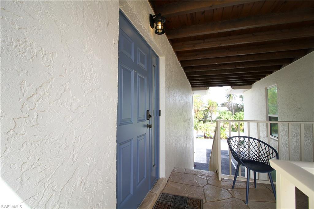 97 Georgetown Boulevard, Unit 97 Naples, FL 34112 - Photo 4 of 26 a view of a balcony with table and chairs