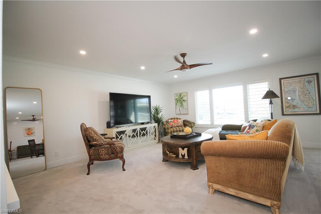97 Georgetown Boulevard, Unit 97 Naples, FL 34112 - Photo 5 of 26 a living room with furniture and a flat screen tv