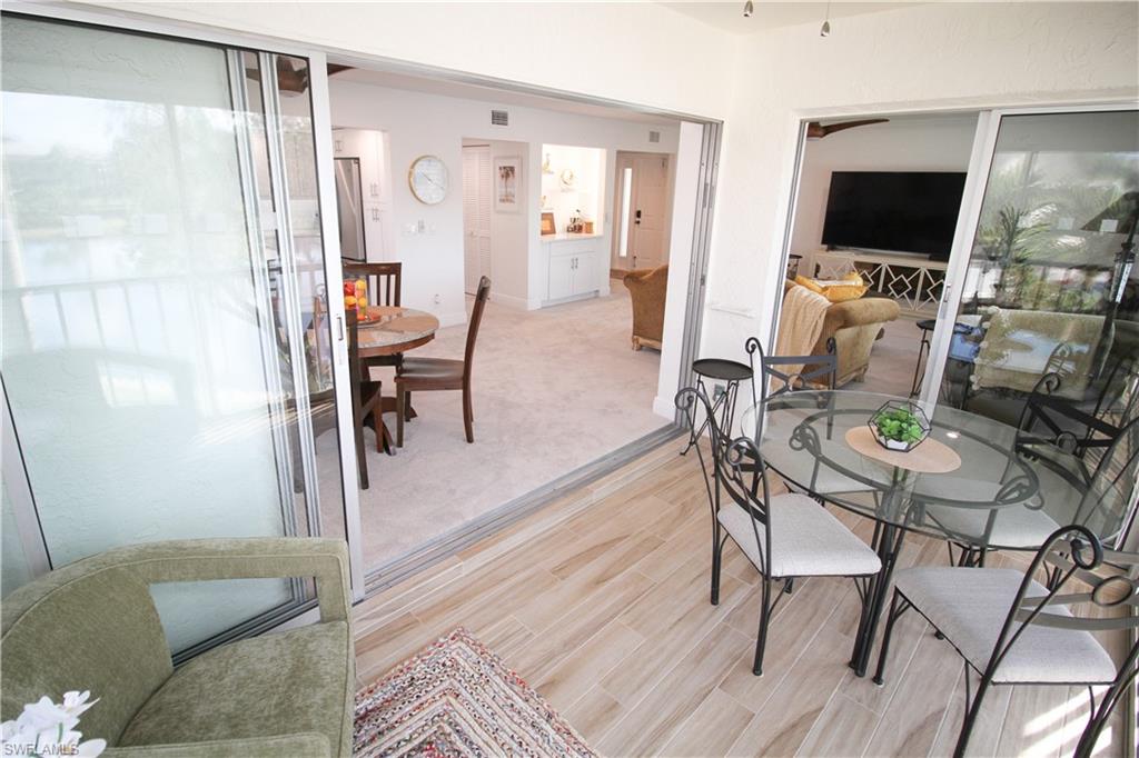 97 Georgetown Boulevard, Unit 97 Naples, FL 34112 - Photo 10 of 26 a living room with furniture and a flat screen tv