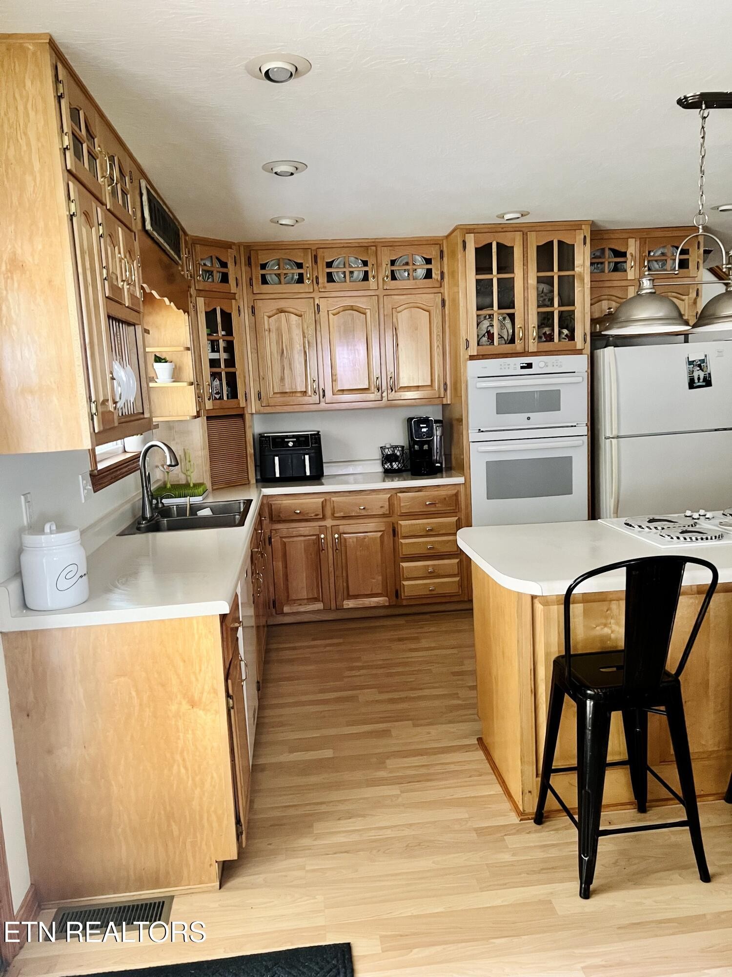 186 Perkins Trail Deer Lodge, TN 37726 - Photo 11 of 54 a kitchen with stainless steel appliances granite countertop a stove a sink and a refrigerator