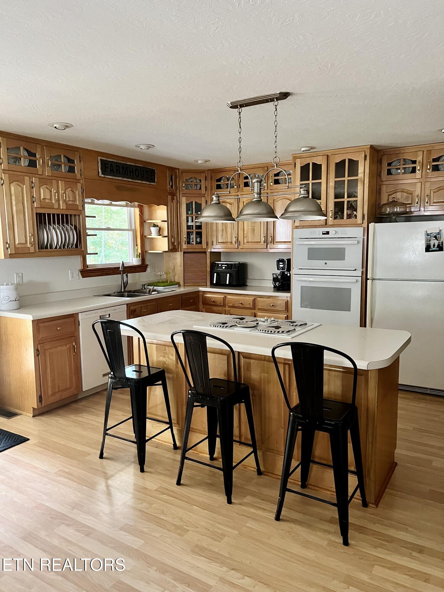 186 Perkins Trail Deer Lodge, TN 37726 - Photo 12 of 54 a kitchen with stainless steel appliances granite countertop a table chairs and a wooden floor