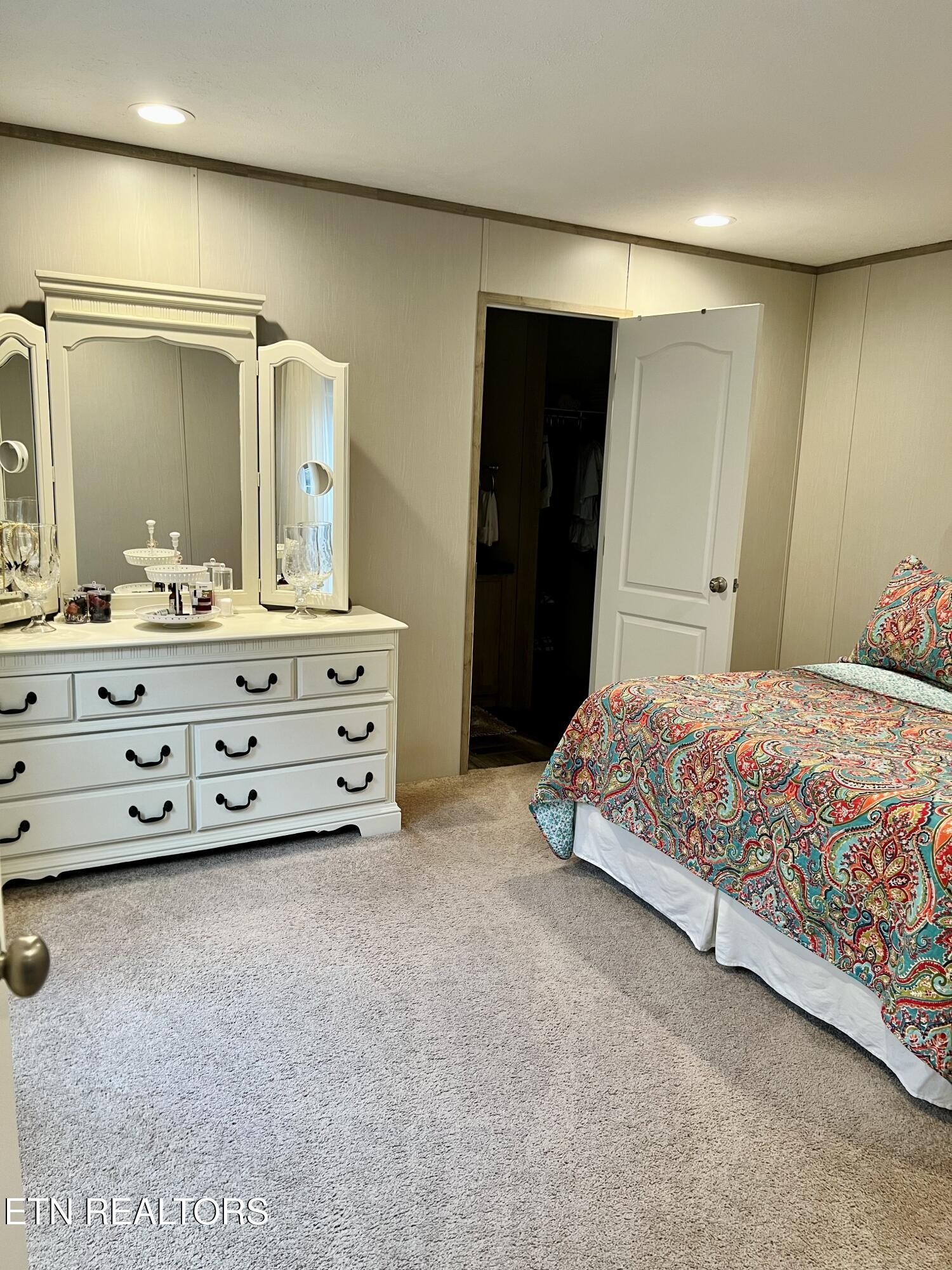 186 Perkins Trail Deer Lodge, TN 37726 - Photo 45 of 54 a bedroom with a bed and a mirror