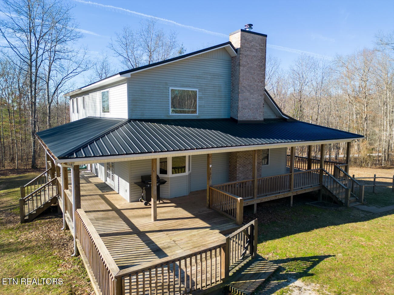 186 Perkins Trail Deer Lodge, TN 37726 - Photo 51 of 54 a view of a patio with table and chairs with wooden floor and fence