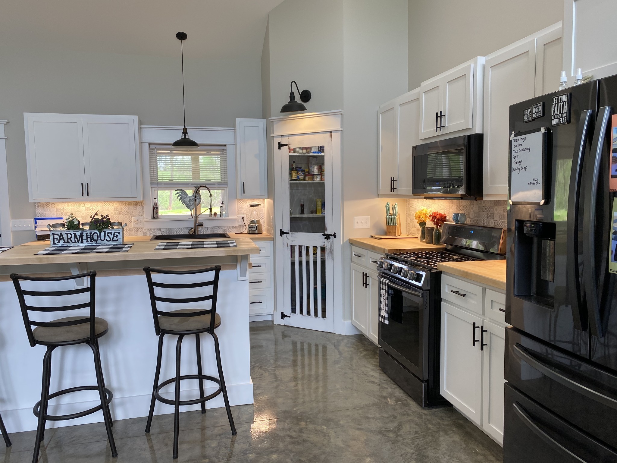 1495 Columbia Road Charlotte, TN 37036 - Photo 12 of 50 a kitchen with stainless steel appliances kitchen island granite countertop a stove a sink and a refrigerator