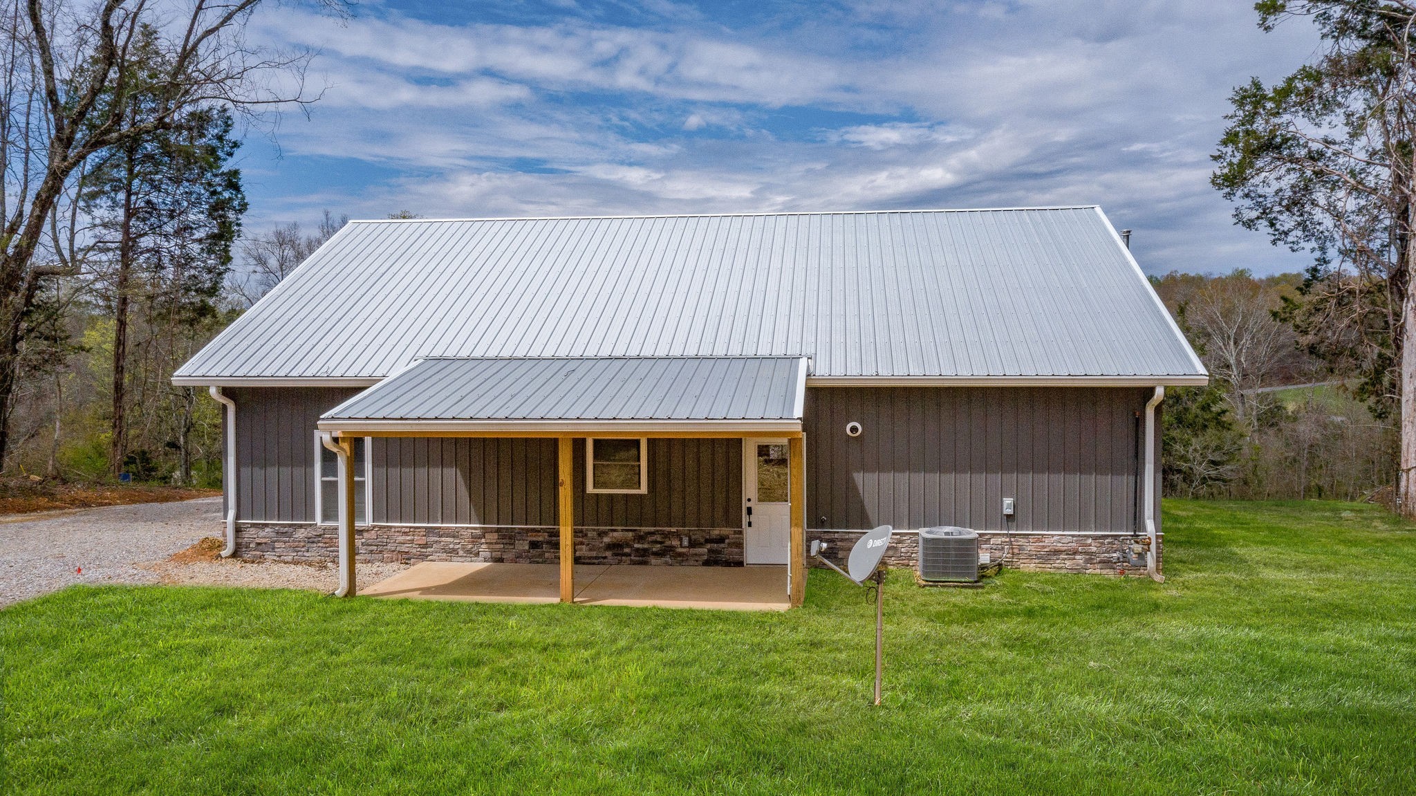 1495 Columbia Road Charlotte, TN 37036 - Photo 29 of 50 a view of a house with a backyard and a patio