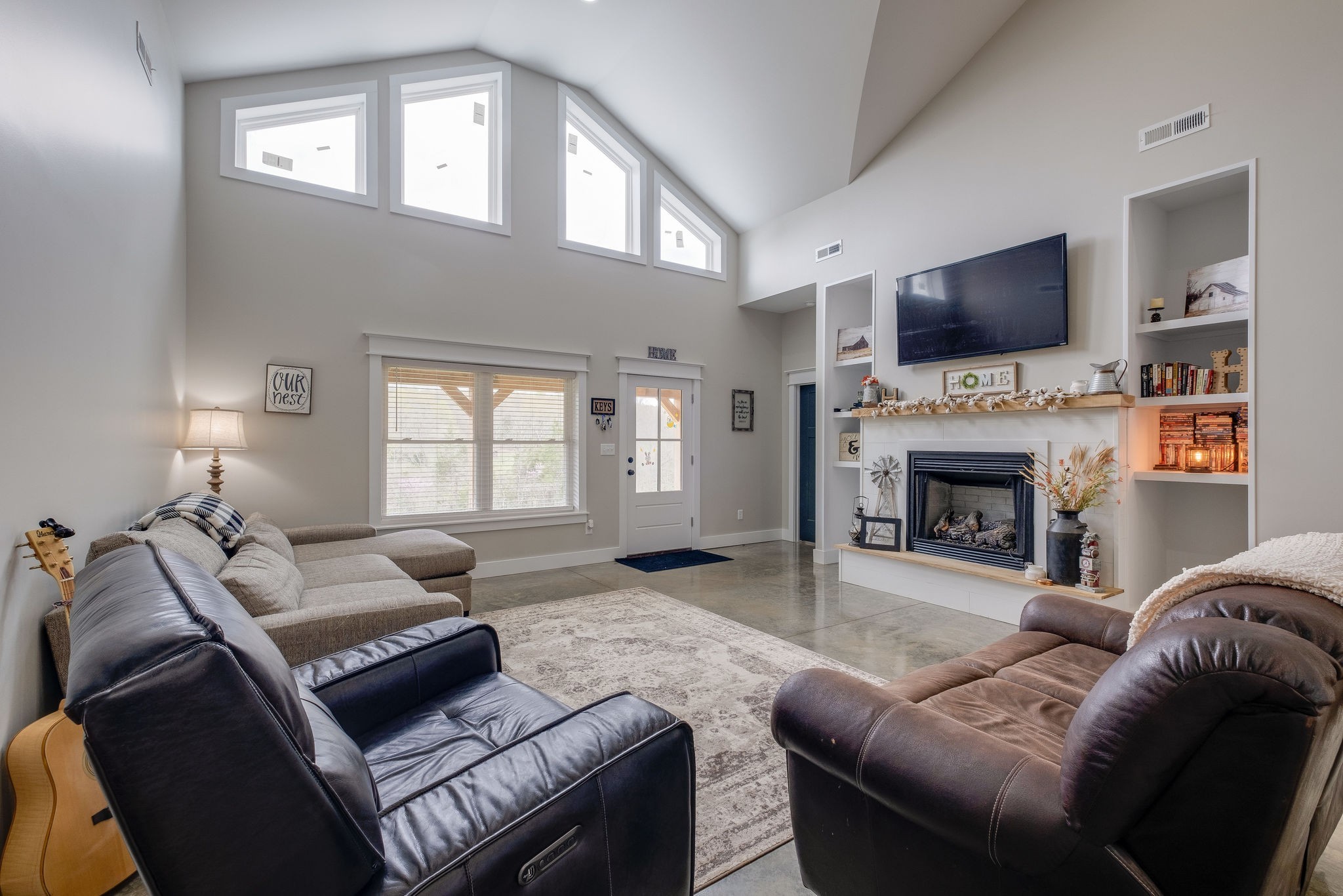 1495 Columbia Road Charlotte, TN 37036 - Photo 4 of 50 a living room with furniture a flat screen tv and a fireplace