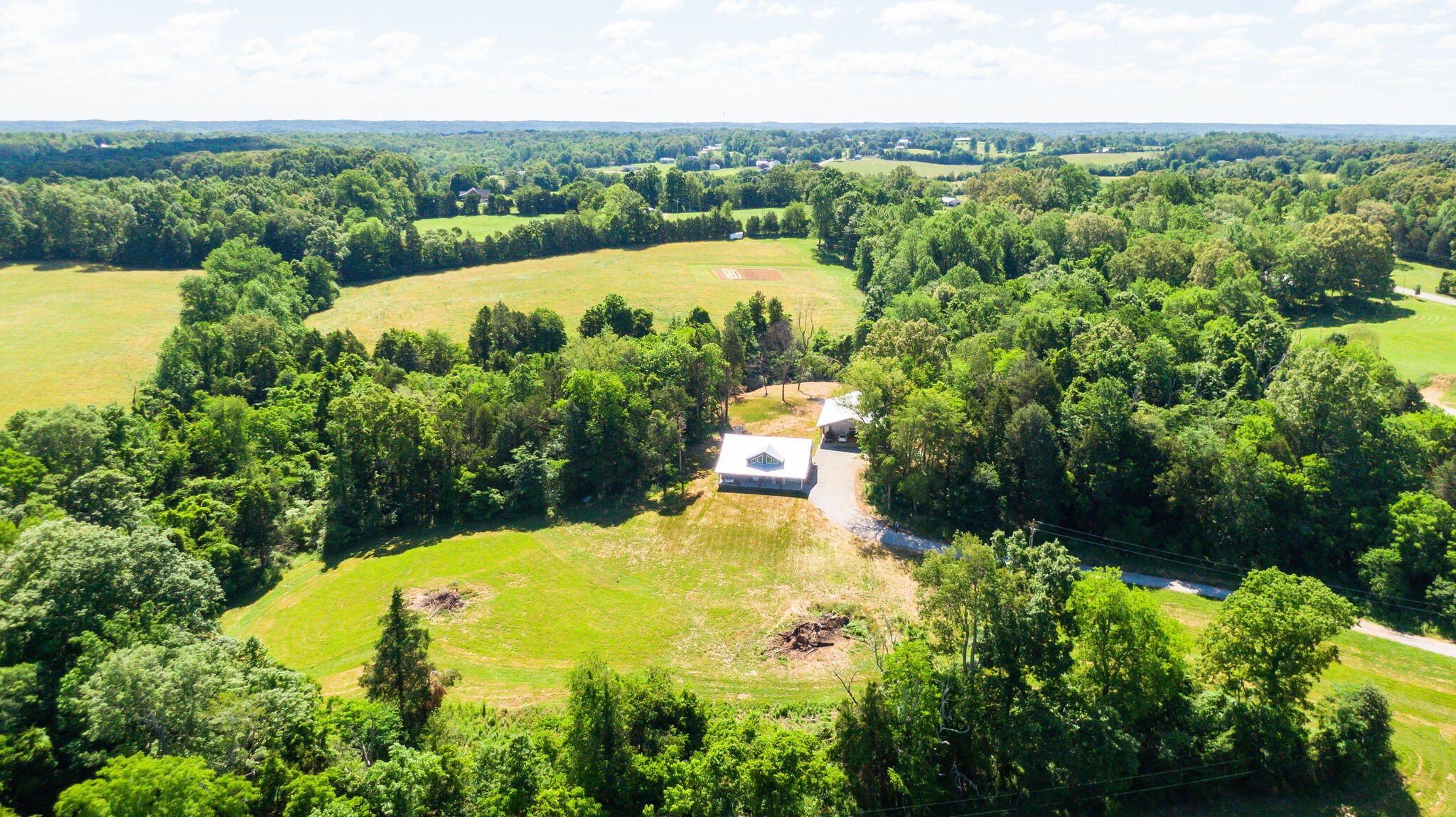 1495 Columbia Road Charlotte, TN 37036 - Photo 46 of 50 an aerial view of a house with a garden and swimming pool
