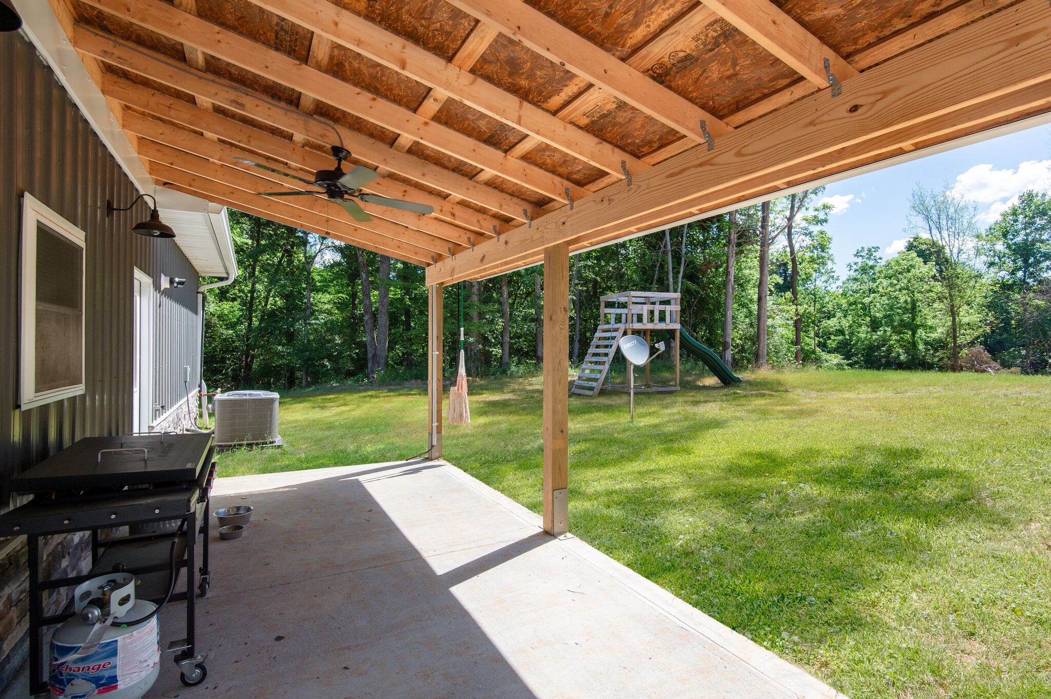 1495 Columbia Road Charlotte, TN 37036 - Photo 47 of 50 a view of a porch with chairs and a backyard