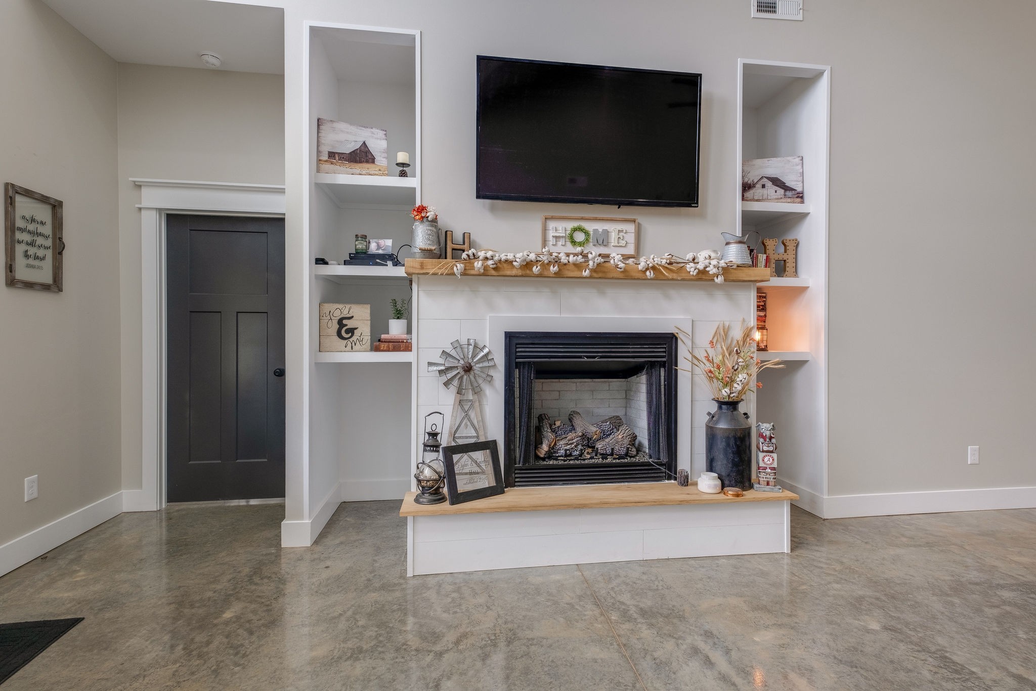 1495 Columbia Road Charlotte, TN 37036 - Photo 6 of 50 a living room with a fireplace and a flat screen tv