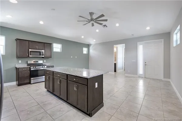 a kitchen with stainless steel appliances granite countertop a stove and a sink
