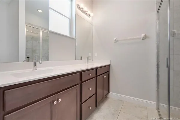 a bathroom with a double vanity sink a and mirror