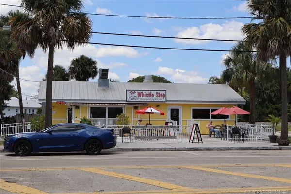 a view of a cars park in front of a building