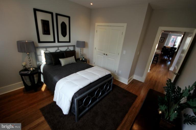 2128 1st Street Northwest, Unit 2 Washington, DC 20001 - Photo 12 of 28 a bedroom with a bed and wooden floor
