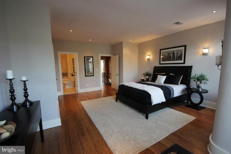 2128 1st Street Northwest, Unit 2 Washington, DC 20001 - Photo 21 of 28 a bedroom with a bed and wooden floor