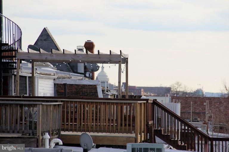 2128 1st Street Northwest, Unit 2 Washington, DC 20001 - Photo 22 of 28 a view of roof deck with two couches and wooden floor