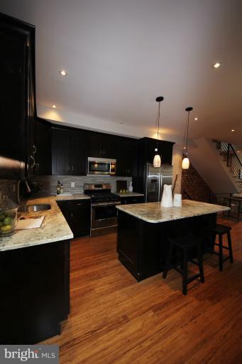 2128 1st Street Northwest, Unit 2 Washington, DC 20001 - Photo 6 of 28 a kitchen with a sink cabinets and wooden floor