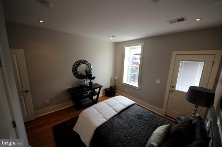 2128 1st Street Northwest, Unit 2 Washington, DC 20001 - Photo 7 of 28 a bedroom with a bed and window