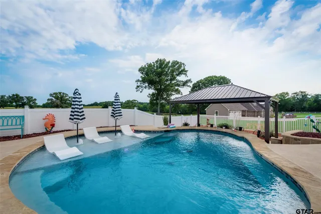an outdoor space with swimming pool and furniture