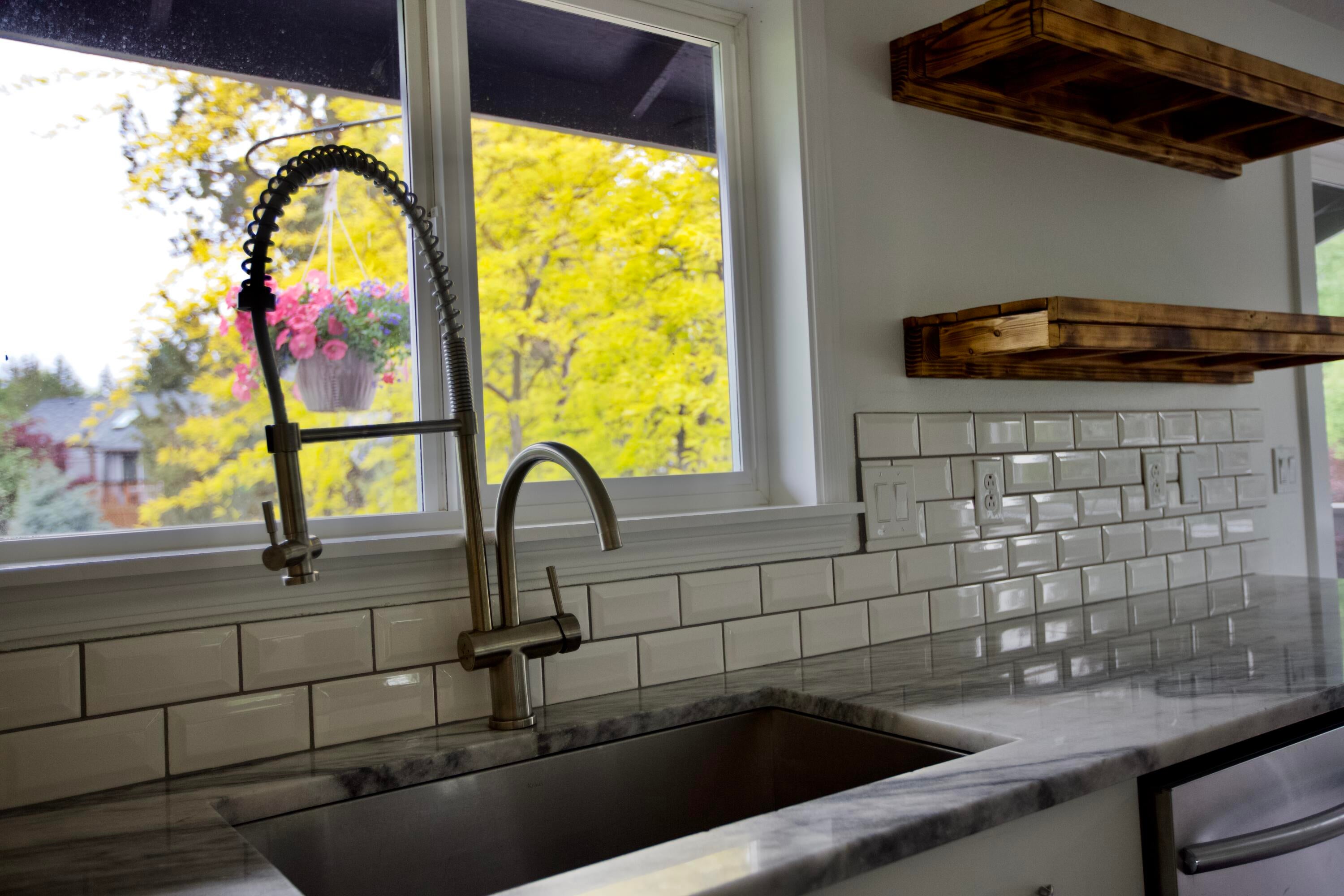 3608 Southwest Volcano Court Redmond, OR 97756 - Photo 11 of 47 Includes quartzite counter tops, subway tile back splash, open wood shelving.
