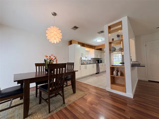 a kitchen with a sink a stove and a window