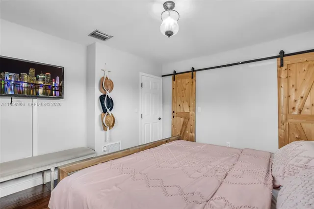 a bedroom with bed and window