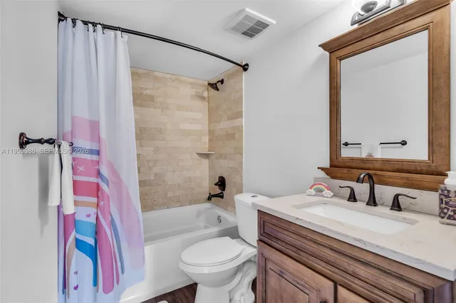 a kitchen with stainless steel appliances kitchen island granite countertop a stove and cabinets