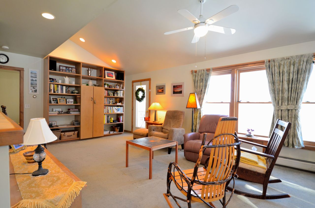 43 Pinnacle Road Otis, MA 01253 - Photo 4 of 16 a living room with furniture a large window and a chandelier