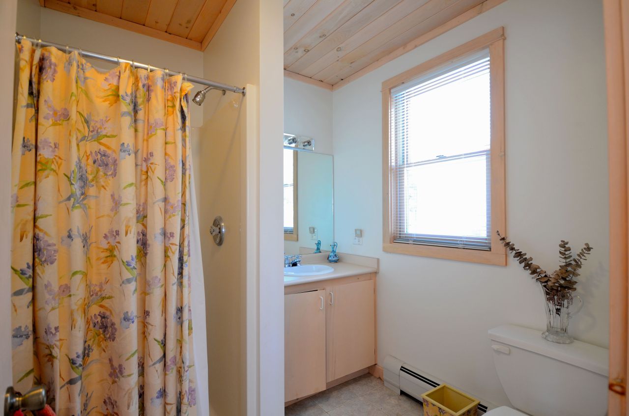 43 Pinnacle Road Otis, MA 01253 - Photo 10 of 16 a bathroom with a sink a mirror and a shower