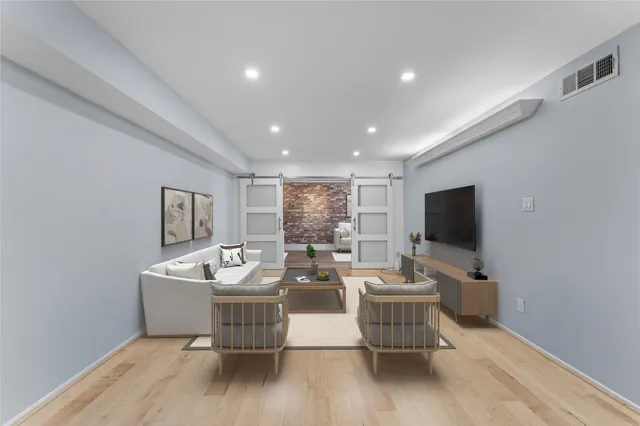 a living room with fireplace furniture and a flat screen tv